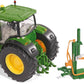 A green diecast scale model of a log splitter with a green tractor